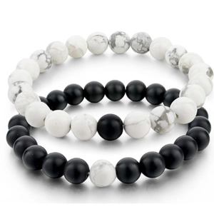 Detailed macro view of 8mm matte black onyx and white turquoise couple bead bracelets