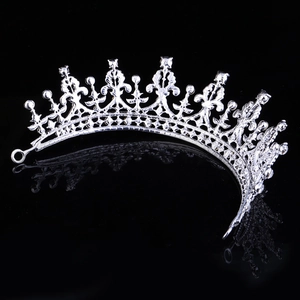 Detail of silver vintage bridal tiara with intricate crystal craftsmanship on black background