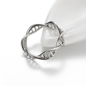 Macro shot of a polished silver ring with a unique DNA double helix structure and base pairs