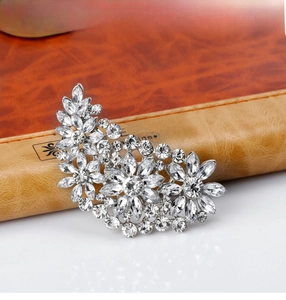 Macro detail of elegant silver-tone floral brooch set with sparkling marquise rhinestones