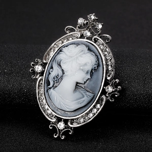 Vintage oval cameo brooch with female portrait and sparkling crystal rhinestones