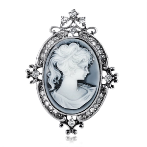 Vintage silver cameo brooch featuring a female profile with sparkling crystals on white