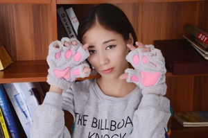 Detailed close-up of grey plush cat paw fingerless gloves with pink 3D paw pads