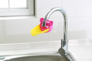 Detailed close-up of a cartoon crab-shaped faucet extender for kids' hand washing