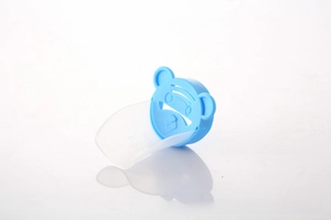 Close-up of blue cartoon bear faucet extender with transparent curved water guide for kids