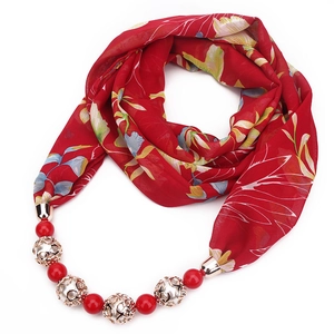 Detail of red floral chiffon necklace scarf with red round beads and gold hollow metal beads