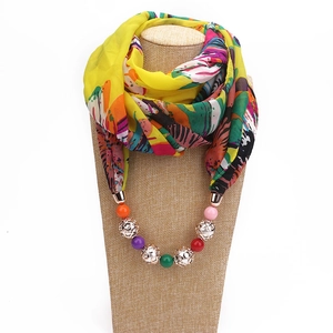 Floral chiffon necklace scarf with colorful beads and gold metal charms on a mannequin