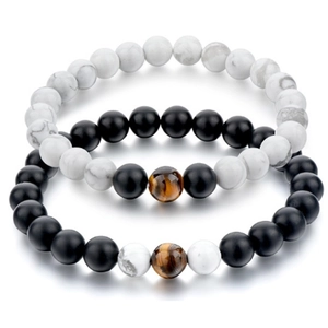 Detail view of 8mm matte black and white marble stone beaded bracelets with tiger eye accent