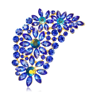 Elegant floral brooch with blue and green rhinestones in a gold metal setting