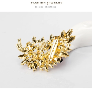 Detail of gold-plated brooch back with secure safety pin and hollow metal structure