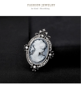 Macro detail of vintage lady cameo brooch with silver alloy and crystal rhinestones