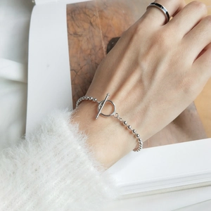 S925 sterling silver beaded bracelet with OT toggle clasp worn on a model's wrist