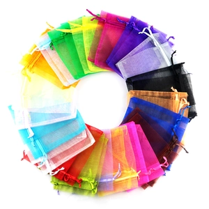 Macro shot of colorful organza drawstring gift pouches arranged in a circular pattern