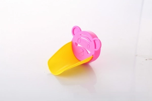 Detail of pink cartoon crab faucet extender with a yellow water guide for toddlers