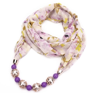 Detail of floral chiffon scarf necklace with purple beads and golden metal accents