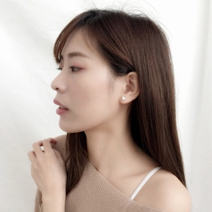 Minimalist cat ear pearl studs shown on a model for a chic and sweet aesthetic look