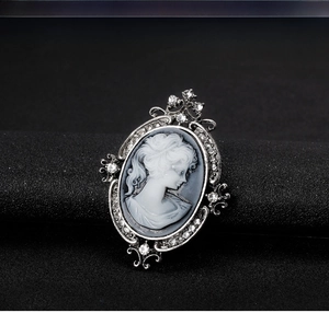 Macro view of vintage cameo brooch with lady profile and crystal rhinestones in silver