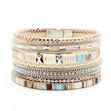 Detail of bohemian multilayer braided leather bracelet with beads and magnetic clasp
