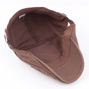 Brown cotton newsboy cap with interior lining detail and metal adjustable side buckle