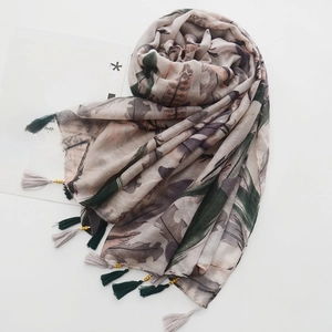 Detail of bohemian cotton linen scarf with feather prints and handcrafted wood bead tassels