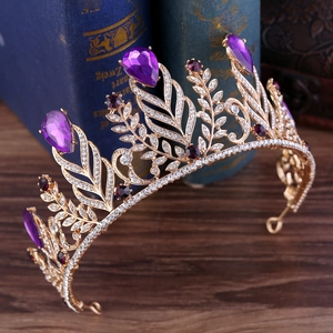 Detailed view of golden baroque crown with purple teardrop crystals and small rhinestones