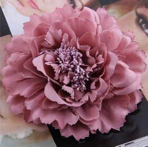 Macro shot of dusty pink artificial rose hair comb showing fabric petal details