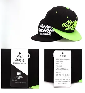 Detail view of snapback hat brand tags with care instructions and logo embroidery