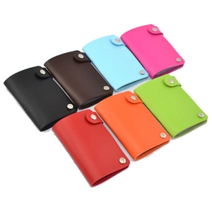 Flat lay of colorful faux leather coin purses with silver snap closures in seven shades