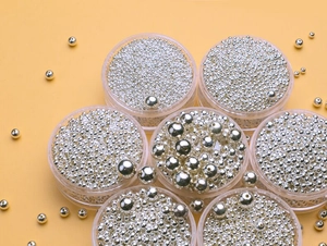 Detailed top view of assorted S925 sterling silver loose round beads in clear containers
