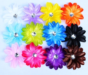 Flat lay of 12 colorful silk rose hair accessories with center rhinestone detailing