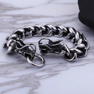 Mens vintage silver dragon head heavy chain bracelet on gray marble background