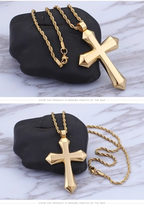 Detailed view of polished gold cross pendant with a classic rope chain necklace