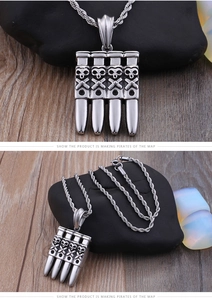 Detail of silver skull and crossbones relief on bullet pendants with a twisted chain