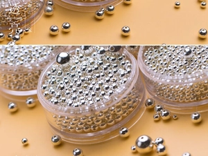 Macro shot of assorted S925 sterling silver loose beads in a clear storage box