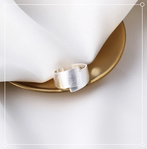 Detailed close-up of wide brushed silver ring featuring matte finish and adjustable open band