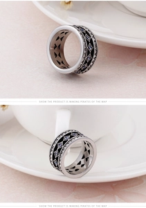 Detail of vintage wide ring featuring white zircon, black enamel, and hollow heart inner band