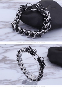 Detailed macro view of vintage stainless steel dragon head bracelet with curb chain