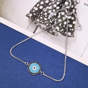 Detail of silver Evil Eye bracelet with blue crystals and adjustable box chain