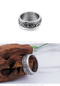Detailed relief of vintage scrolls on a silver titanium steel men's ring band