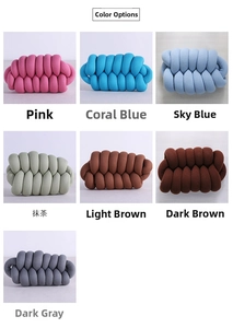 Detail view of handmade knot pillows in various colors including pink, blue, and green