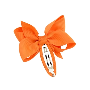 Cute orange fabric bow hair clip for girls with comfortable fabric wrapped snap clip base