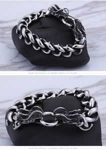 Detail of dragon head clasp and heavy stainless steel cuban chain bracelet for men