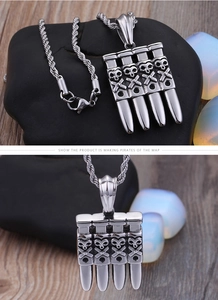 Detail of a punk pirate skull pendant with silver metal bullet shapes and rope chain