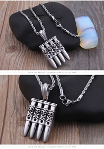 Macro shot of punk style bullet pendants with embossed skull and crossbones on twist chain