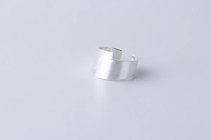 Macro detail of minimalist S925 sterling silver wide ring with brushed texture finish