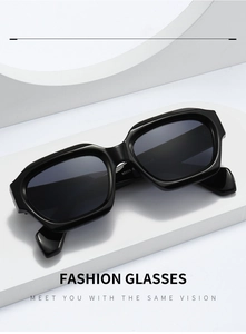 Detail view of bold black polygonal sunglasses showing frame texture and model number