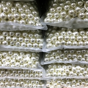 Macro view of polished cream white round faux pearl beads for jewelry and DIY crafts