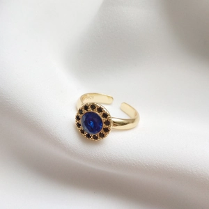 S925 silver gold-plated adjustable ring with blue sapphire and black stones on white silk