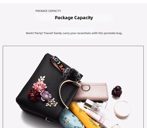 Spacious interior of black pebble leather tote showing daily essentials and flower detail