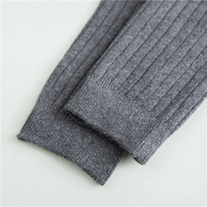 Macro shot of dark grey ribbed knit texture on high-quality cotton mid-calf socks